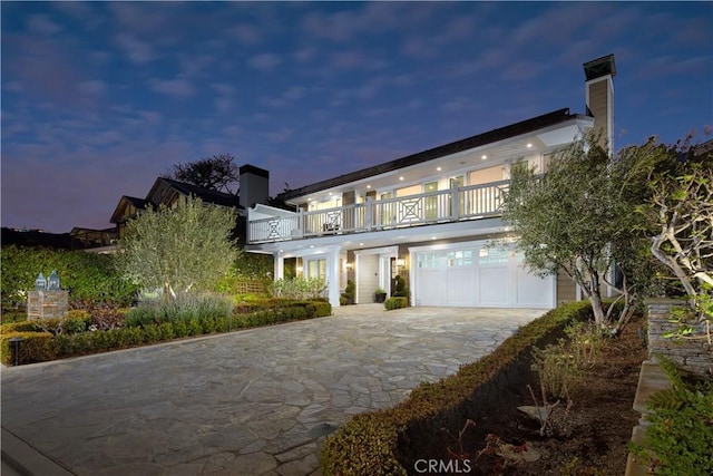 89 S La Senda Dr, Laguna Beach, CA 92651 - contemporary house with a chimney, decorative driveway, and a balcony