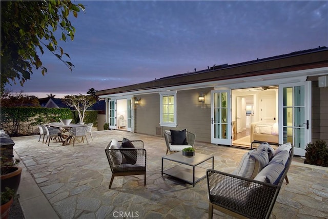 89 S La Senda Dr, Laguna Beach, CA 92651 - patio terrace at dusk featuring french doors, an outdoor hangout area, and outdoor dining space