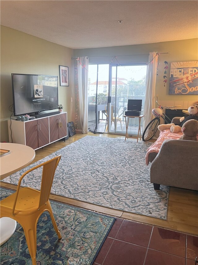 450 E 4th St Unit 304, Santa Ana, CA 92701 - tiled living area featuring a textured ceiling