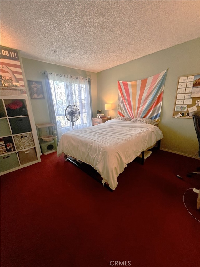 bedroom with carpet flooring and a textured ceiling
