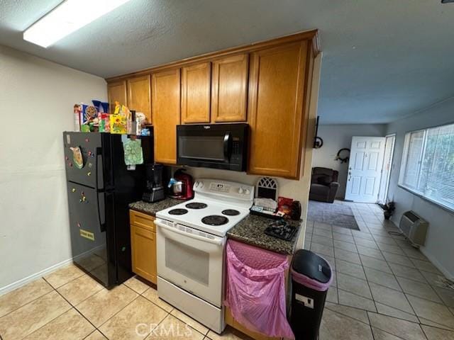 505 E Madison Ave Unit 84, El Cajon, CA 92020 - kitchen with black appliances, brown cabinetry, light tile patterned floors, and dark countertops