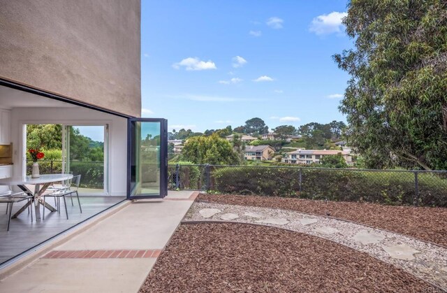 view of yard with fence, a patio area, and outdoor dining space