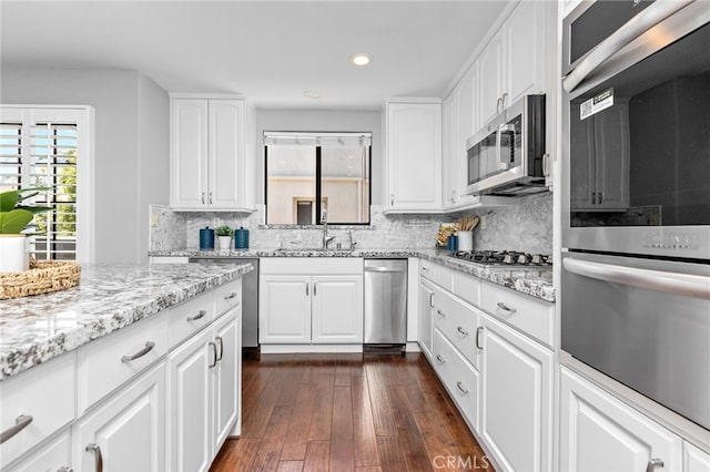 515 N Gertruda Ave Unit 9, Redondo Beach, CA 90277 - kitchen featuring appliances with stainless steel finishes, a sink, recessed lighting, tasteful backsplash, and light stone countertops