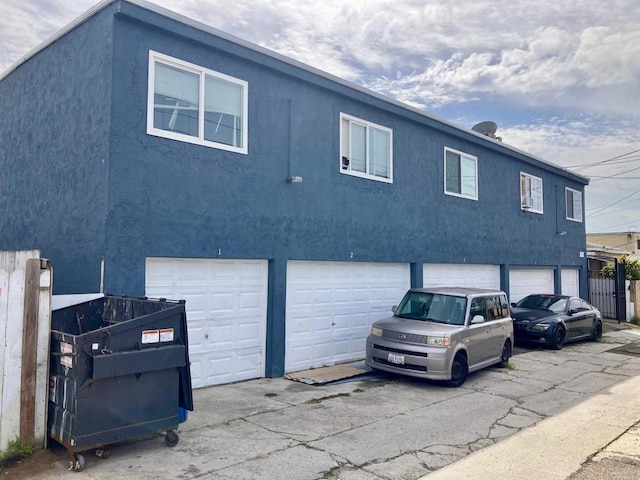 view of front of house with an attached garage and stucco siding