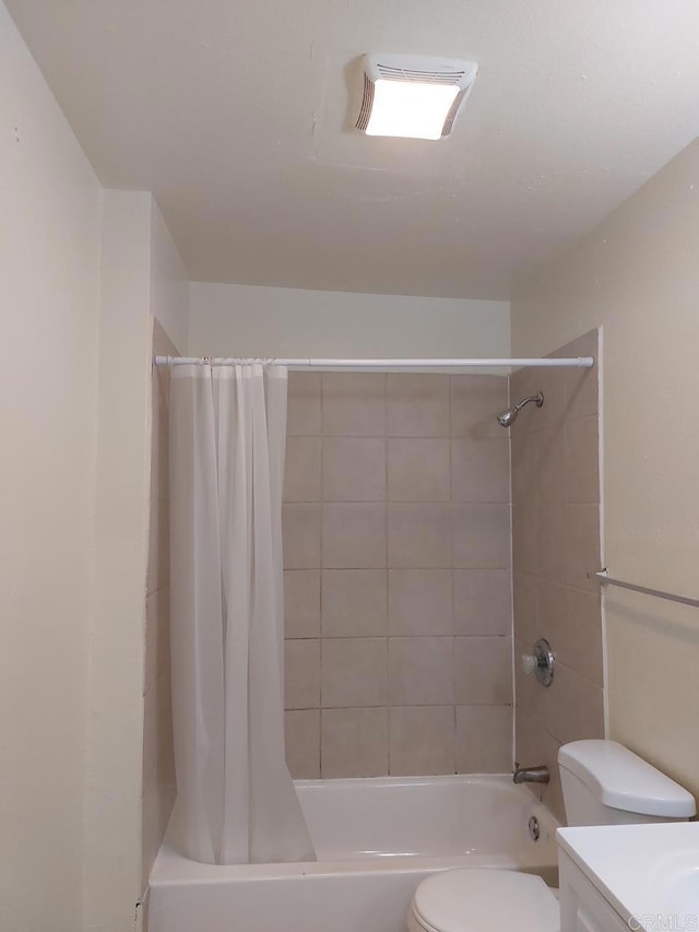 full bathroom featuring vanity, shower / bath combination with curtain, and toilet