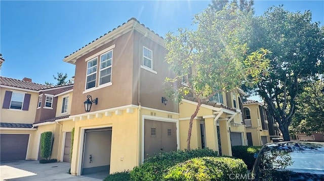 120 Timberwood, Irvine, CA 92620 - view of front of property with an attached garage, stucco siding, a tile roof, and driveway