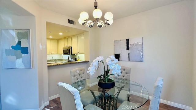 120 Timberwood, Irvine, CA 92620 - dining space with a chandelier, dark wood-style floors, and baseboards