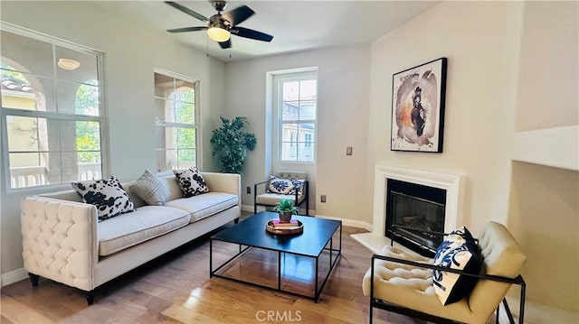 120 Timberwood, Irvine, CA 92620 - living area with wood finished floors, a ceiling fan, a glass covered fireplace, and baseboards