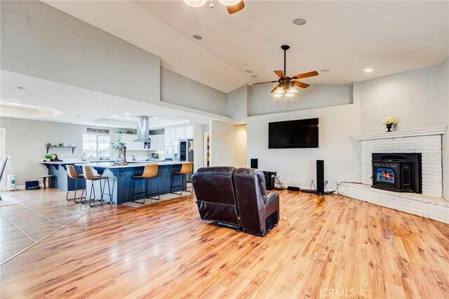 living room featuring light wood-style floors, a ceiling fan, lofted ceiling, and recessed lighting