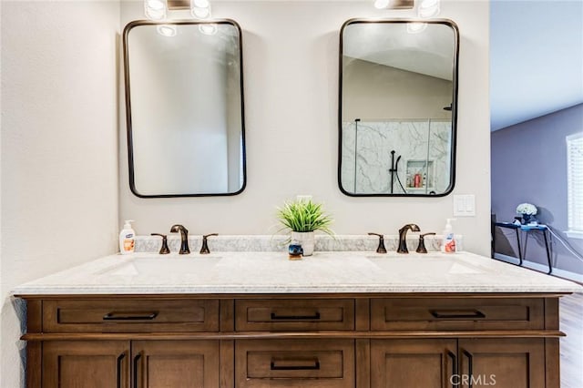 full bathroom featuring wood finished floors, double vanity, and a sink