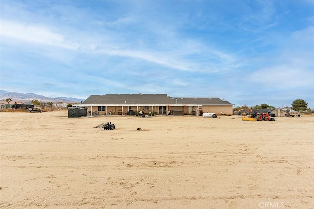 back of property with a mountain view