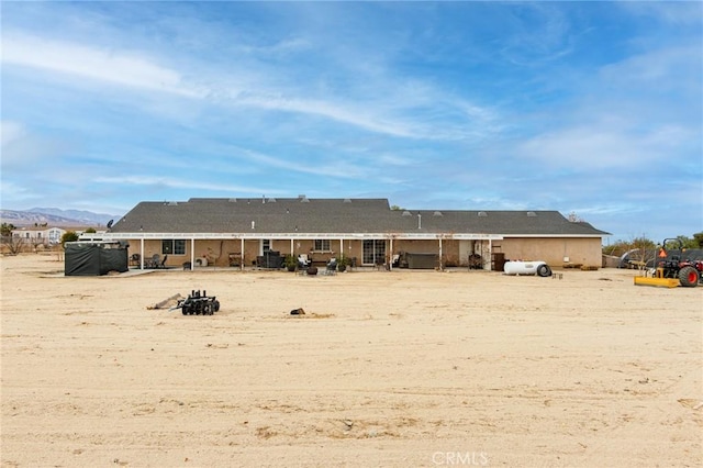 rear view of property with a patio area and a mountain view