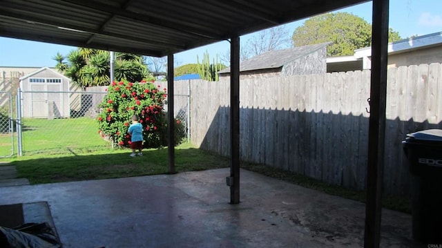 view of patio / terrace with a fenced backyard, an outdoor structure, and a storage shed