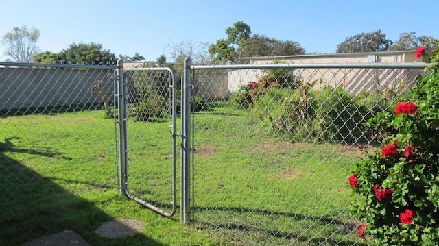 view of yard with fence and a gate