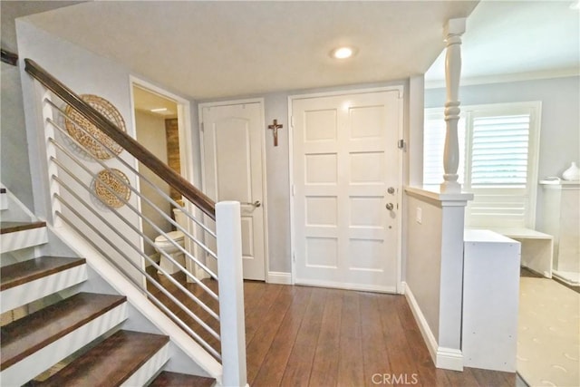 entrance foyer featuring stairs, baseboards, and wood-type flooring