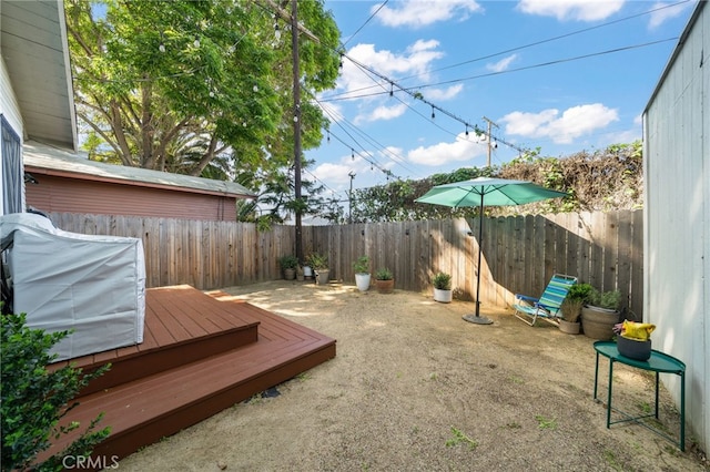 view of yard featuring a fenced backyard and a wooden deck