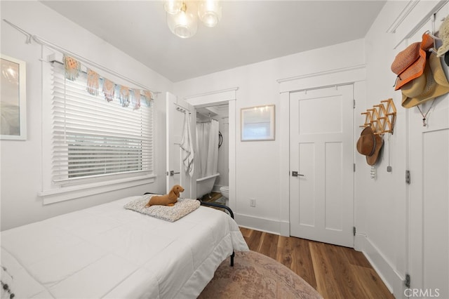 bedroom featuring baseboards and wood finished floors