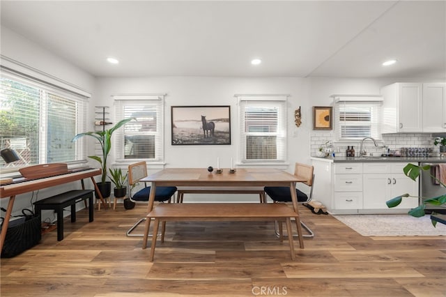 dining room featuring recessed lighting, light wood finished floors, and plenty of natural light
