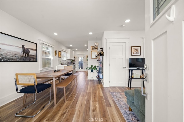 dining room with baseboards, recessed lighting, and light wood-style flooring