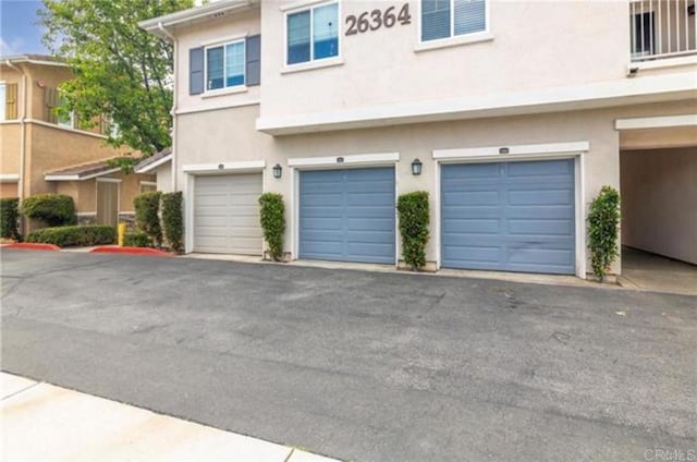 26364 Arboretum Way Unit 3301, Murrieta, CA 92563 - garage with aphalt driveway