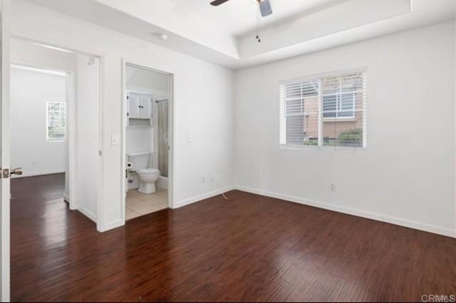 26364 Arboretum Way Unit 3301, Murrieta, CA 92563 - unfurnished bedroom featuring a raised ceiling, wood finished floors, baseboards, and ensuite bath