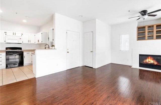 26364 Arboretum Way Unit 3301, Murrieta, CA 92563 - unfurnished living room with recessed lighting, a ceiling fan, wood finished floors, and a fireplace with flush hearth