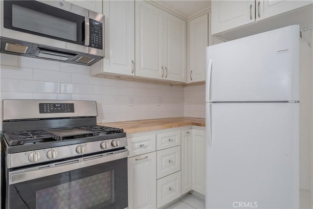 kitchen with backsplash, wooden counters, white cabinetry, and stainless steel appliances