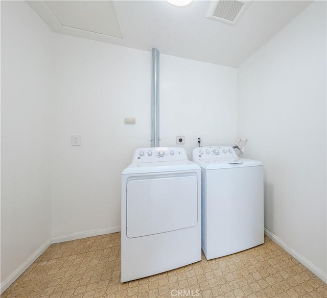 laundry room featuring visible vents, light floors, washing machine and dryer, and laundry area