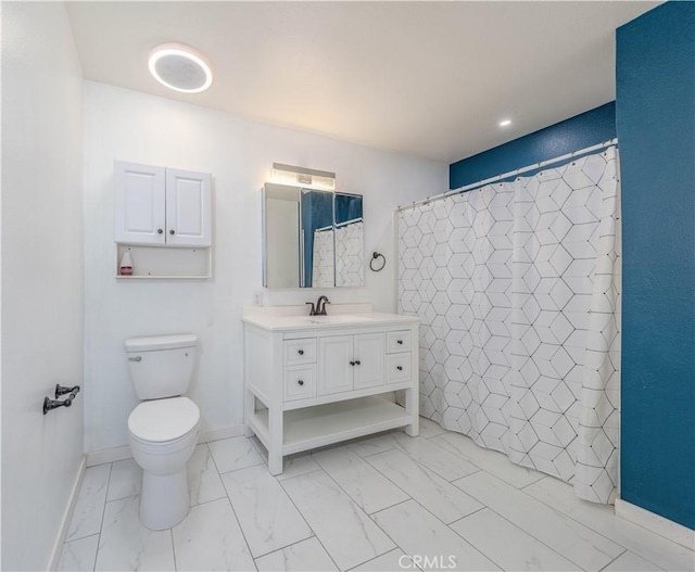 bathroom with vanity, toilet, marble finish floor, a shower with shower curtain, and baseboards