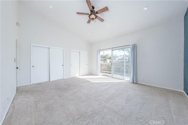 unfurnished bedroom featuring two closets, high vaulted ceiling, recessed lighting, carpet floors, and access to exterior