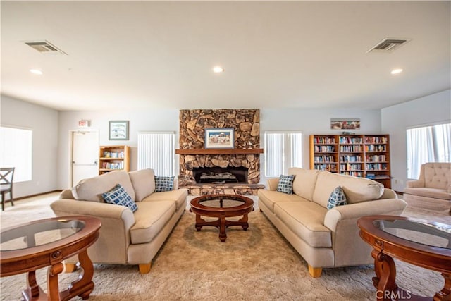 4433 Albatross Way, Oceanside, CA 92057 - living room featuring recessed lighting, light colored carpet, and a stone fireplace