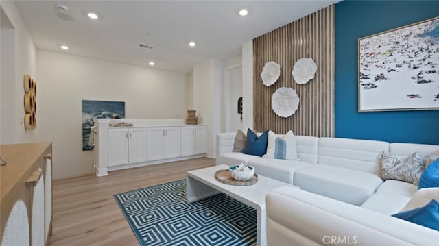 living area featuring recessed lighting, visible vents, and light wood-style floors