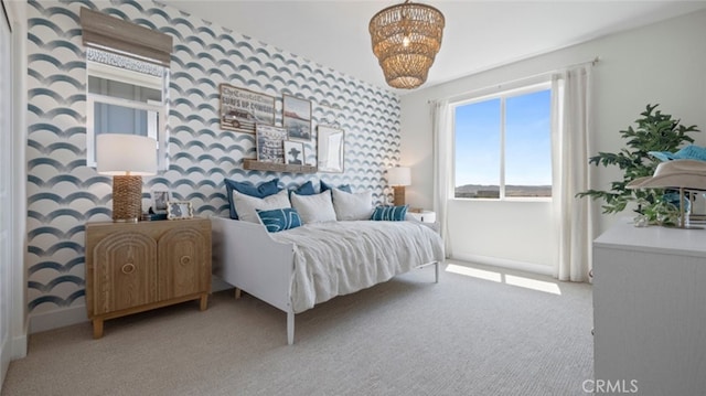 carpeted bedroom with a chandelier, wallpapered walls, and baseboards