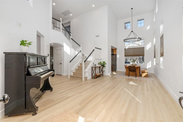 4355 Leonard Way, Corona, CA 92883 - entryway featuring a towering ceiling, a notable chandelier, stairway, and wood finished floors