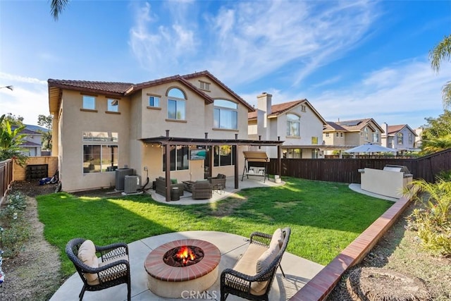 4355 Leonard Way, Corona, CA 92883 - rear view of property featuring an outdoor living space with a fire pit, a patio area, stucco siding, a lawn, and a fenced backyard
