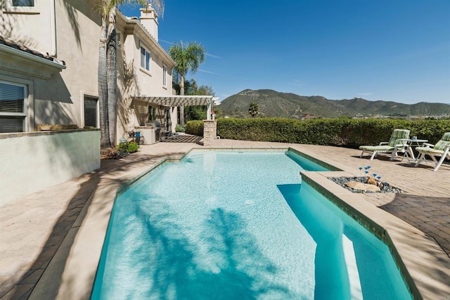view of swimming pool featuring a mountain view, a patio area, a fenced in pool, and a pergola