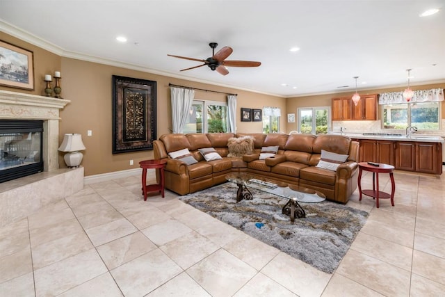 living area featuring ceiling fan, light tile patterned flooring, ornamental molding, and a fireplace