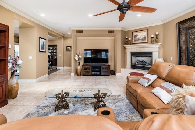 living room with visible vents, baseboards, crown molding, and ceiling fan