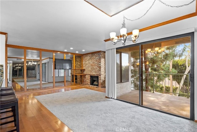 7201 Apricot Dr Unit 7201, Irvine, CA 92618 - unfurnished living room with a chandelier, a fireplace, hardwood / wood-style floors, and recessed lighting