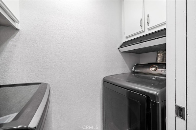 7201 Apricot Dr Unit 7201, Irvine, CA 92618 - laundry area with washer / dryer, cabinet space, and a textured wall