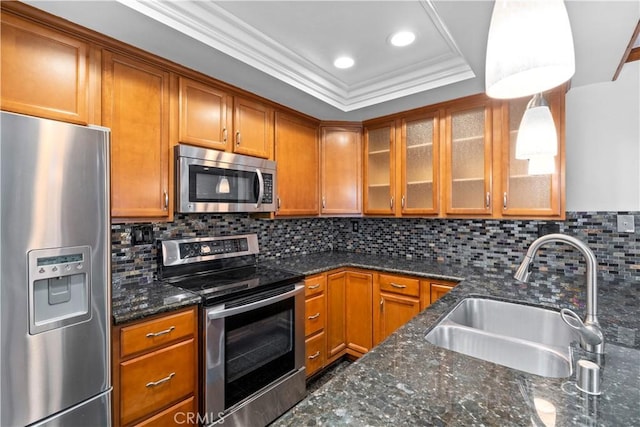 7201 Apricot Dr Unit 7201, Irvine, CA 92618 - kitchen featuring stainless steel appliances, brown cabinets, glass insert cabinets, ornamental molding, and dark stone counters