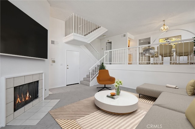 9000 Vanalden Ave Unit 155, Northridge, CA 91324 - living area featuring visible vents, carpet floors, stairs, a tiled fireplace, and a notable chandelier