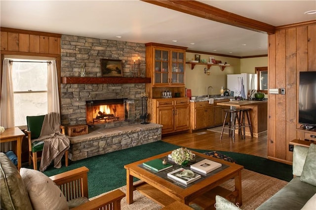 29196 Lake Brook Ave, Cedar Glen, CA 92321 - living room with a stone fireplace, dark wood-type flooring, ornamental molding, and wooden walls