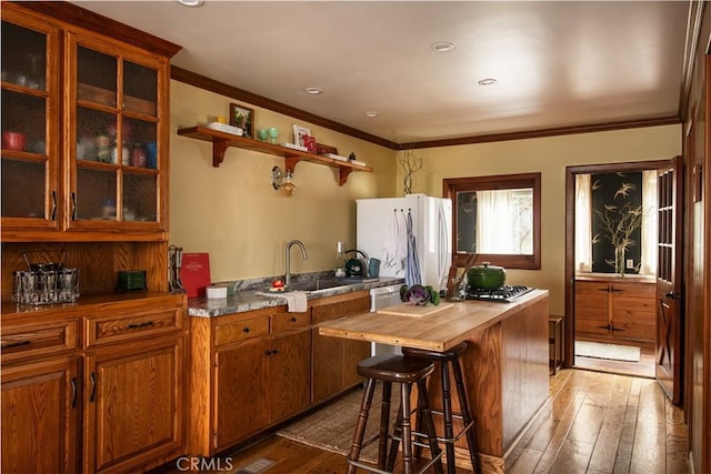 29196 Lake Brook Ave, Cedar Glen, CA 92321 - kitchen with brown cabinets, light wood finished floors, a sink, freestanding refrigerator, and wood counters