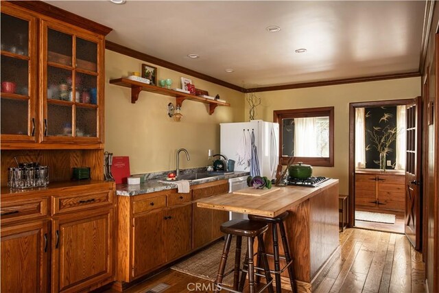 29196 Lake Brook Ave, Cedar Glen, CA 92321 - kitchen featuring freestanding refrigerator, wooden counters, light wood-type flooring, brown cabinets, and glass insert cabinets