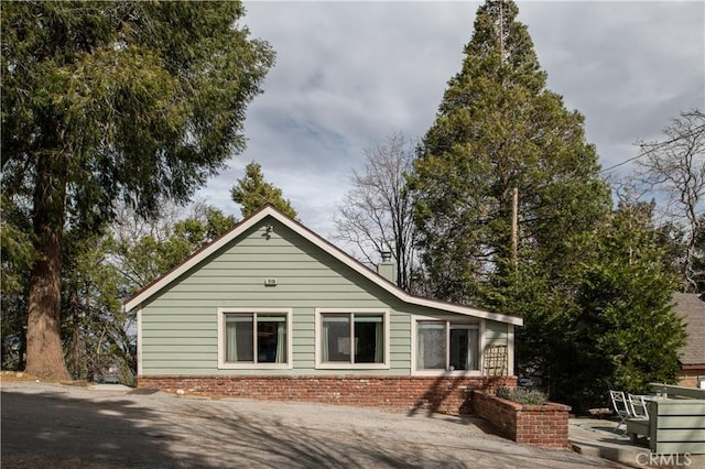29196 Lake Brook Ave, Cedar Glen, CA 92321 - view of home's exterior featuring a chimney and brick siding