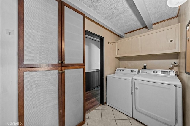 579 E 40th St, San Bernardino, CA 92404 - washroom featuring cabinet space, washer and clothes dryer, light tile patterned floors, and a textured ceiling