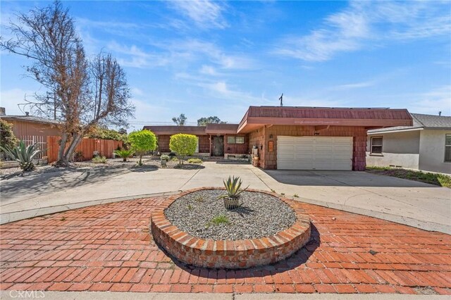 579 E 40th St, San Bernardino, CA 92404 - view of front of house with curved driveway and an attached garage