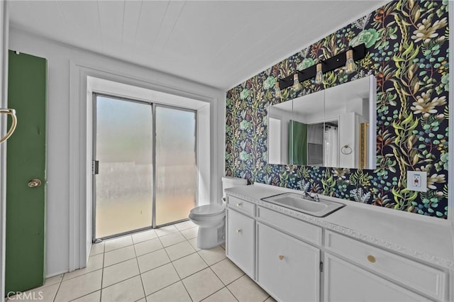 579 E 40th St, San Bernardino, CA 92404 - bathroom with wallpapered walls, vanity, tile patterned flooring, and toilet