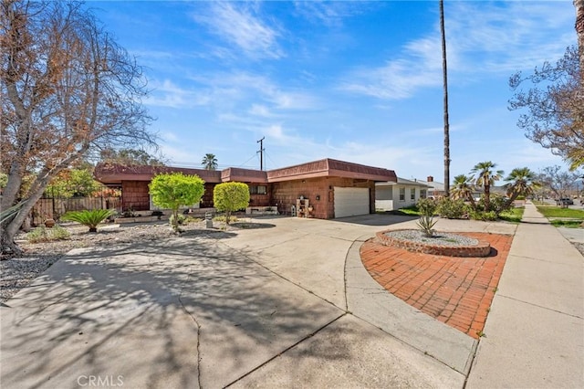 579 E 40th St, San Bernardino, CA 92404 - view of front facade featuring driveway and an attached garage